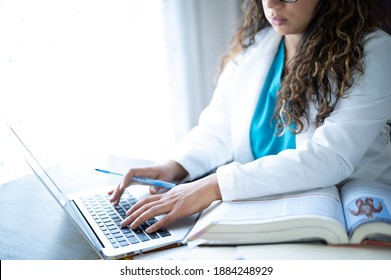 Milwaukee, Wisconsin - November 20, 2020: A Female Doctor Writing Orders On The Laptop Computer