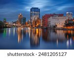 Milwaukee, Wisconsin, USA. Cityscape image of downtown Milwaukee, Wisconsin, USA with reflection of the skyline in Mnemonee River at twilight blue hour.