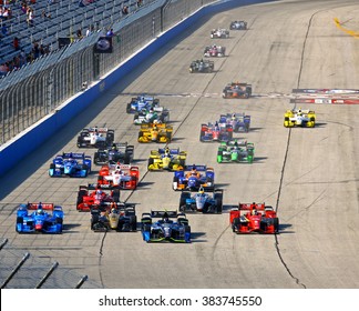 Milwaukee Wisconsin, USA - July 12, 2015: Verizon Indycar Series Indyfest ABC 250 Milwaukee Mile. Cloud of dust, smoke, green flag Indy car racing.  Indy racecars vying for position side by side start