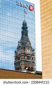 Milwaukee, Wisconsin, USA- July 17, 2022: Milwaukee City Hall Sky Scraper Center Reflected In The Glass BMO Building.