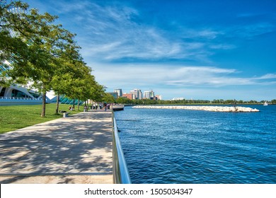 Milwaukee, Wisconsin / USA - September 14, 2019: A scenic walkway alongside Lake Michigan beside the Milwaukee Art Museum. This scene features blue water and a view of the city on the distance.