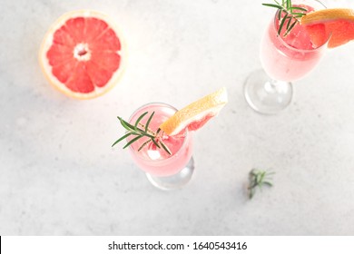 Mimosa Cocktail With Champagne, Grapefruit And Rosemary In Flute Glasses, Top View, Copy Space. Mocktail, Mimosa Sparkling Citrus Drink.