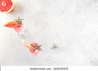 Mimosa Cocktail With Champagne, Grapefruit And Rosemary In Flute Glasses, Top View, Copy Space. Mocktail, Mimosa Sparkling Citrus Drink.