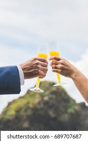 Mimosa Toast In Front Of Rocks On Beach In Costa Rica