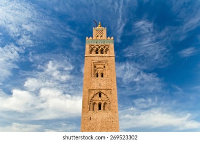 Minaret of ancient mosque in Marrakech. Dramatic sky