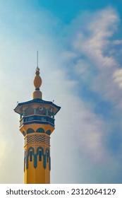 the minaret of a mosque against a backdrop of blue sky and cloudy twilight - Shutterstock ID 2312064129