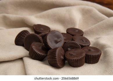 Minature Dark Chocolate Peanut Butter Cups On A Napkin