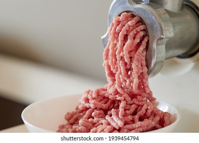 mince meat with an electric meat grinder in the domestic kitchen, selective focus - Powered by Shutterstock