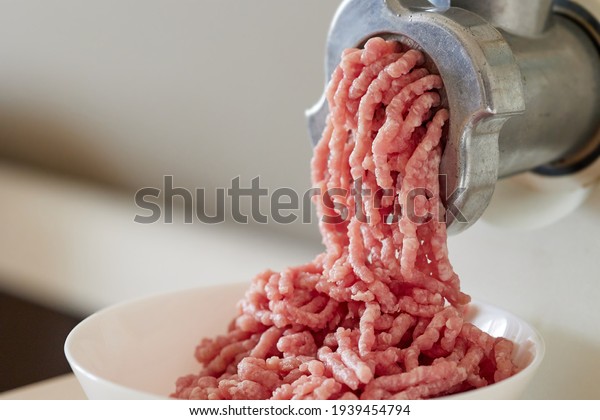 mince meat with an electric meat grinder\
in the domestic kitchen, selective\
focus