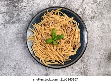 Mince Meat Pasta With Basil Leaves On A Round Plate On A Dark Gray Background. Top View, Flat Lay