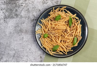 Mince Meat Pasta With Basil Leaves On A Round Plate On A Dark Gray Background. Top View, Flat Lay