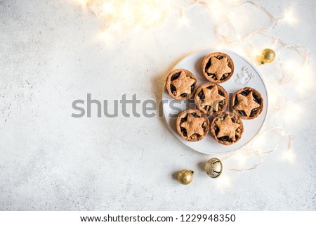Mince Pies for Christmas on white background with light, copy space. Traditional Christmas dessert - fruit mince pies. Stock photo © 