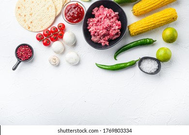 Minced Beef Meat With Raw Ingredients For Tacos With , Corn Tortillas, Chili, Avocado, Over White Background. Top View With Space For Text.