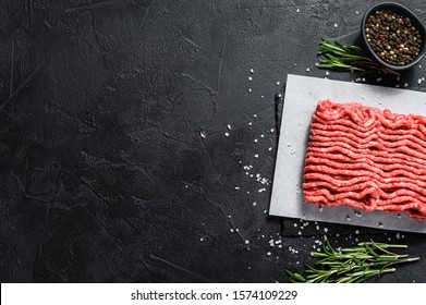 Minced marble beef. Black background. Top view. Space for text