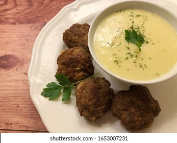 Minced meat balls, also rissoles with mashed potatoes and herbs.
