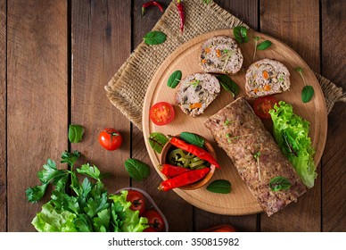 Minced Meat Loaf Roll With Mushrooms And Carrots. Top View