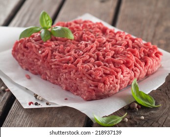 Minced Meat On Butcher Paper With Basil And Pepper, Selective Focus