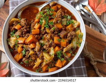 Minced Meat Stew With Cabbage And Carrots. Cooked With Ground Beef And Served In A Rustic Bowl On Wooden Background