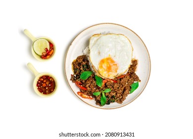 Minced Pork with Basil on Rice with Fried Egg isolated on a white background, top view