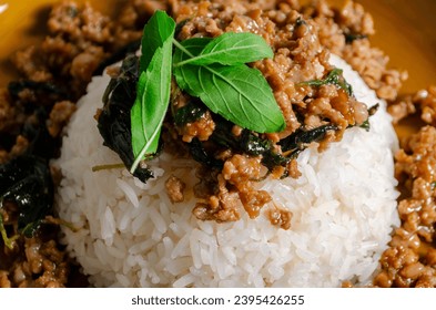 Minced pork with basil over rice is a Thai food that is popular among Thai people because it is delicious and easy to eat - Shutterstock ID 2395426255