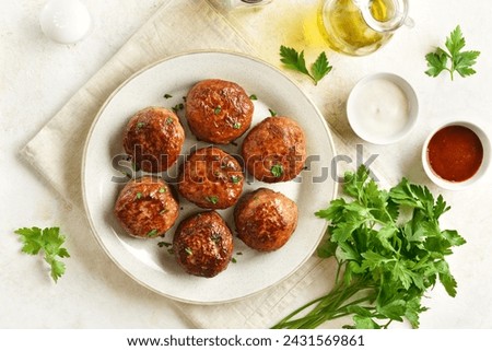 Minced pork and beef cutlets served with sauce over white background. Comfort food concept. Top view, flat lay