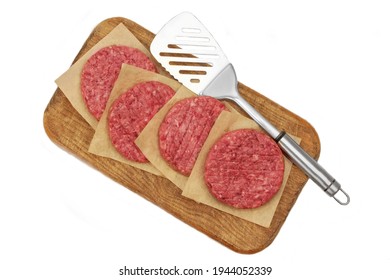 Minced Raw Steak Burgers From Beef Pork Meat On Cutting Board Isolated On White Background, Overhead View. Uncooked Ground Meat Patties For Grilling. Burgers For BBQ Grill And Spatula, Top View.