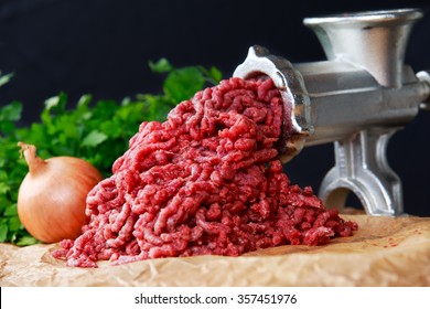 Mincer with fresh minced meat.