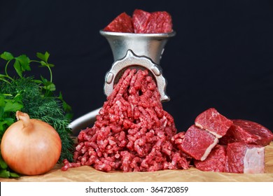 Mincer with fresh minced meat.