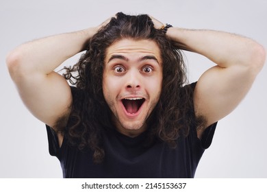 Mind. Blown. Studio Portrait Of A Handsome Young Man Looking Surprised Against A Grey Background.