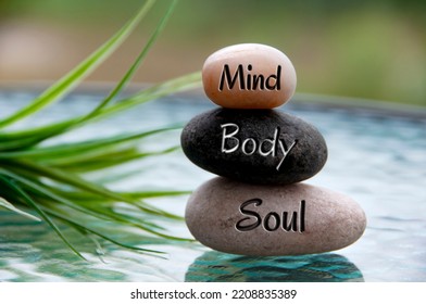 Mind, Body and Soul words engraved on zen stones with space for text. Copy space and zen concept - Shutterstock ID 2208835389
