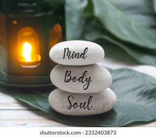 Mind, Body and Soul words engraved on zen stones with black lamp background. Zen concept - Shutterstock ID 2332403873