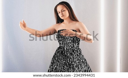 Mind control. Digital hypnosis. Brainwashing influence. Obedient emotionless marionette woman posing in black and white glitch static noise dress light background.