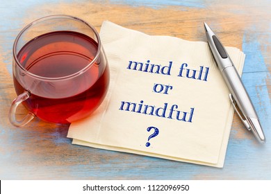 Mind full or mindful   Inspiraitonal handwriting on a napkin with a cup of tea. - Shutterstock ID 1122096950