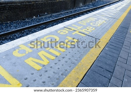 "Mind The Gap" markings on a railway platform