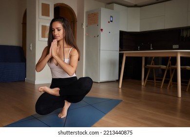 Mind Harmony. Closeup Shot Of Young Beautiful Woman Meditating With Closed Eyes, Calm Brunette Female Practicing Meditation Or Praying, Keeping Hands In Namaste Gesture Near Face.