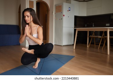 Mind Harmony. Closeup Shot Of Young Beautiful Woman Meditating With Closed Eyes, Calm Brunette Female Practicing Meditation Or Praying, Keeping Hands In Namaste Gesture Near Face.