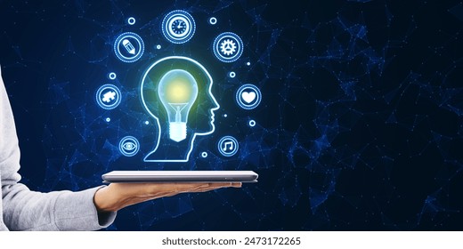Mind mapping and creative inspiration concept. Close up of female hand holding smartphone with glowing head outline and digital lamp and polygonal icons on blurry blue background with mock up place