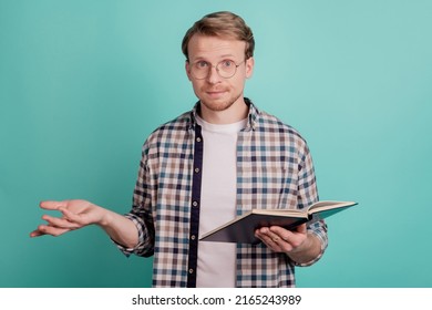 Minded Geek Student Guy Hold Book Clueless Face Shrug Shoulders Isolated On Teal Color Background