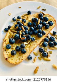 Mindful Food Choices Reward Us With Good Health. Try Toasted Cracked Wheat Sourdough Bread With Vegan Butter And Fresh Organic Blueberries Topped With Roasted Pumpkin Seeds For A Health Boost!