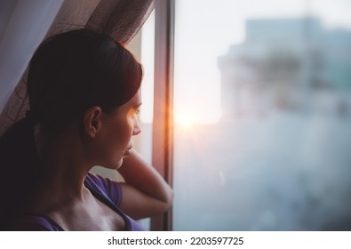 Mindfulness Concept. Authentic Portrait Of A Nice Woman Looking At The Sunset Light. Domestic Life. People At Home