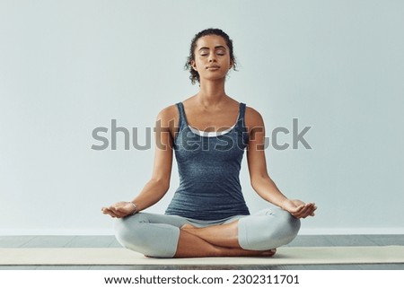 Mindfulness, meditation and woman do yoga for wellness, breathing exercise and healthy body in studio. Mindset, spiritual zen and calm female person meditate for wellbeing, peace and holistic balance