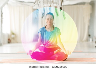 mindfulness, spirituality and healthy lifestyle concept - woman meditating in lotus pose at yoga studio over rainbow aura - Shutterstock ID 1390266002