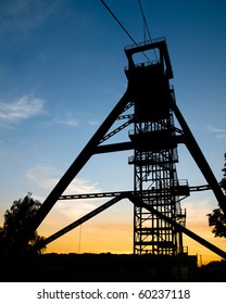 A Mine Shaft Tower At Sunset