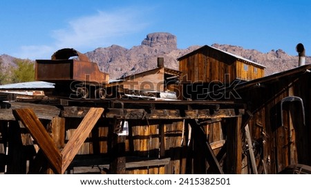 A minecart at the Arizona ghost town of Castle Dome City, not far from the town of Yuma, near Mexico and California, with desert mountains behind it, in January of 2024.