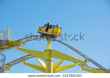 Minecart goes up the yellow roller coaster rails