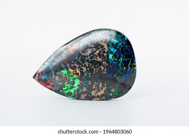 Mined from Queensland fields solid black matrix boulder opal. Red, orange, green, yellow, amber, violet and turquoise color play. Treated, carbonated  to darken and stabilized. Horizontal position.