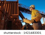 Miner engineer planer holding a planing book while looking up crashing chute during shut down operation Sydney mite site, Australia