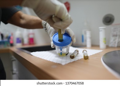 Miner Experimenter Using Rubber Glove While Conducting Safety Urine Drug And Alcohol Testing In The Laboratory At Mine Site Prior To Work On High Risk, Perth, Australia  