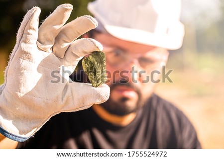 miner holding gold nugget, point focus on the gemstone. Mineral exploration concept, Minnesota, United States