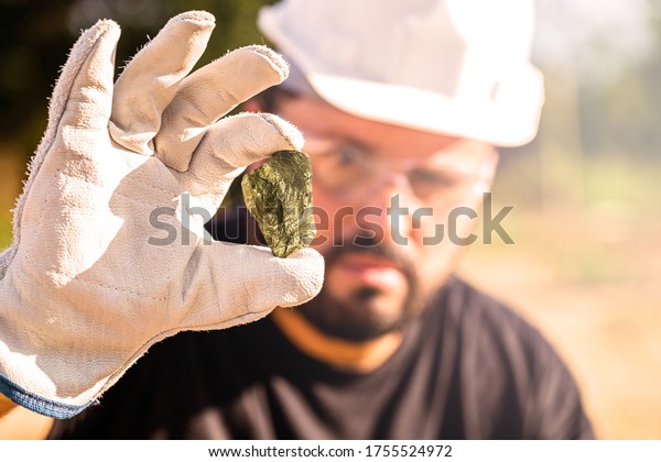 miner\
holding gold nugget, point focus on the gemstone. Mineral\
exploration concept, Minnesota, United\
States